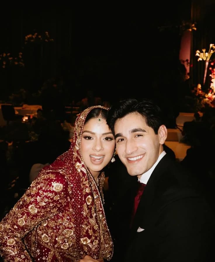 The couple cheek to cheek, caught mid-laugh