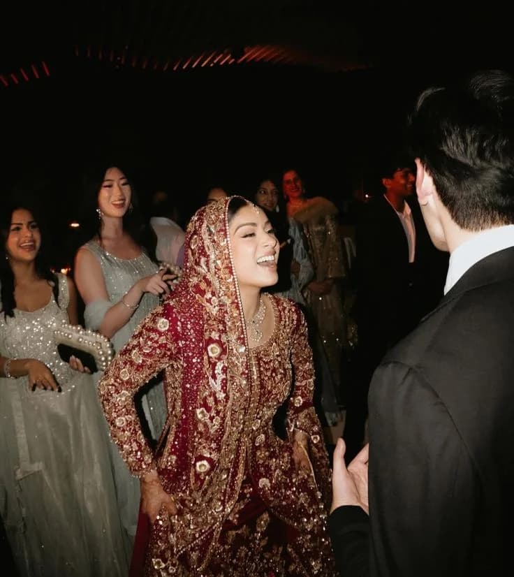 The bride laughing with her friends on the dance floor