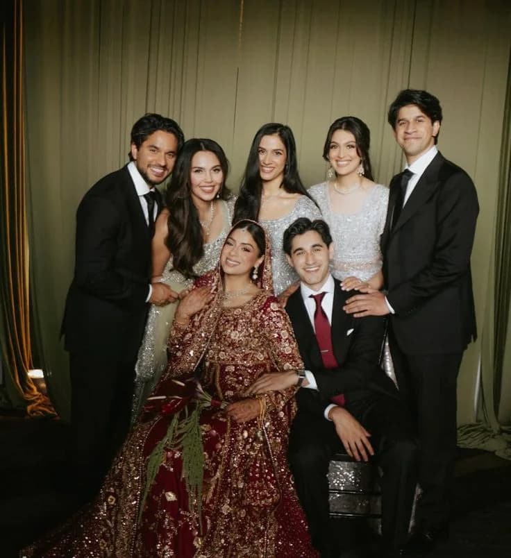 The wedding party gathered around the couple